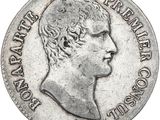 a close up of a coin with a man ' s face on it
