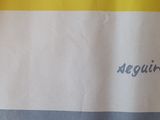 a yellow and white shower curtain with a name on it