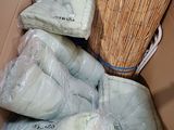 many bags of toilet paper and a broom in a box