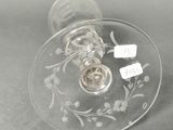 a wine glass with a label on it sitting on a table