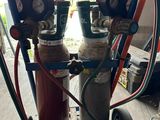 a picture of a propanene cart with two propanene cylinders on it