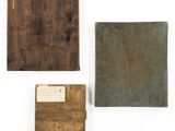 three old books are sitting on top of a white surface