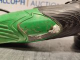 a close up of a shoe with a green sole