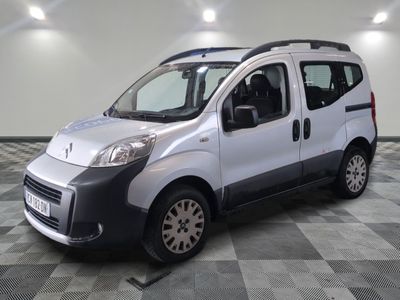 a picture of a silver van parked on a checkered floor