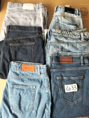 three pairs of levi ' s jeans are stacked on top of each other