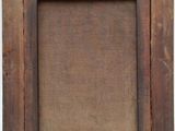 an old wooden frame with a small hole in the middle of it