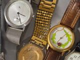 a lot of watches that are sitting on a table