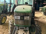 two tractors that are parked inside of a building