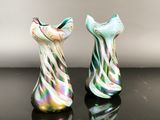 two glass vases that are sitting on a table