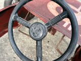 a steering wheel of a vintage car on the street