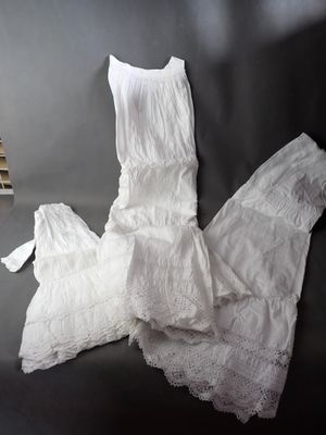 a white dress on a table next to a stack of books