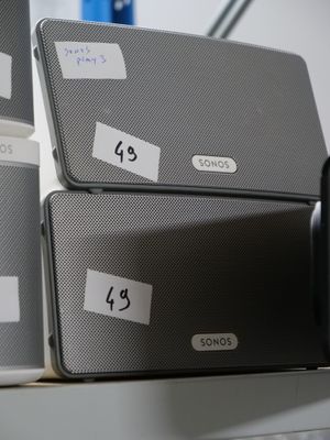 three boxes with labels on them sitting on a shelf