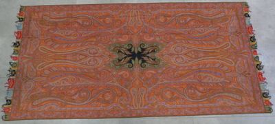an orange and blue rug with a decorative design on it