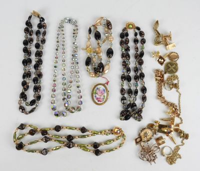 many necklaces and bracelets laid out on a table