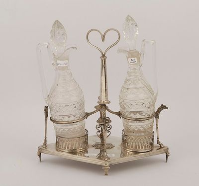 two glass vases on a metal stand with a heart shaped handle