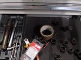 a drawer full of tools in the trunk of a car