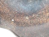 a rusted helmet that is sitting on a table