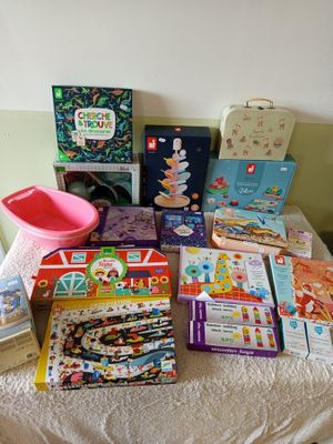 many children ' s books and toys on a table