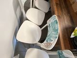 four chairs that are sitting in a row on the floor