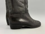 the back view of a pair of black leather boots on a white background