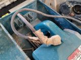 a blue box with a hose in it and a piece of paper in the back of it