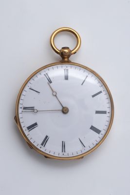 a gold pocket watch with roman numerals on the face