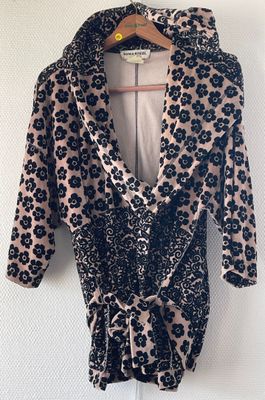 a black and white floral print dress hanging on a hanger