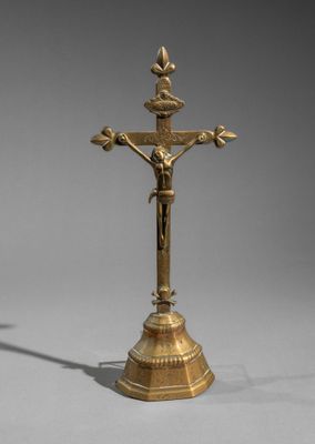 an antique brass crucif with a cross on top of it