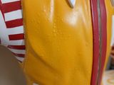 statue of a mcdonald ' s cow wearing a red and white striped shirt