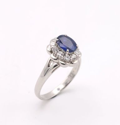 a blue sapphire and diamond ring on a white background