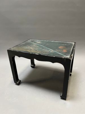 an image of a black table with a marble top on a white surface