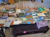 a table full of books and wine glasses on top of it