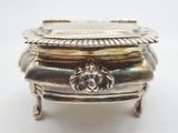 an antique silver plate with a lion head on top of it