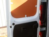 a white van with its door open in the grass