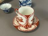 a cup and saucer sitting on a table next to a bowl