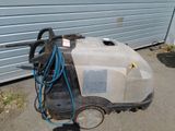 a machine that is sitting on the ground next to a garage
