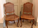 two chairs sitting next to each other on a tiled floor