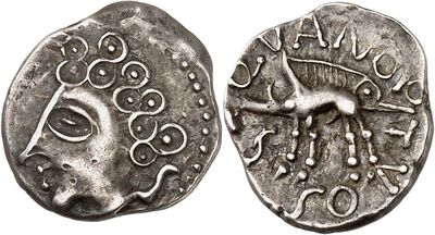 a silver coin with an image of a horse on it