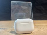 a small white object sitting on a table next to a clear box