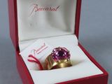 a pink ring in a red box with a red ribbon