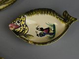 a plate with a fish design on it next to a plate with a fish design on it