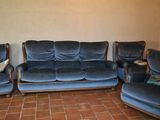 a blue couch and two chairs in a living room