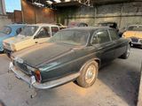 many old cars parked in a garage with a lot of rust