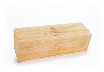 a wooden box with a label on it sitting on a white surface
