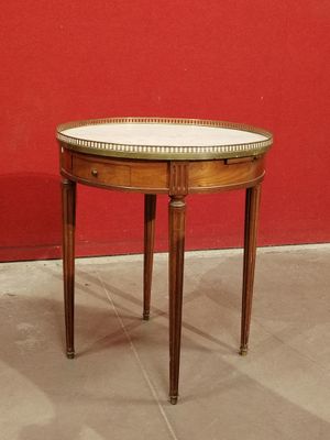 a small round table with a white top on it
