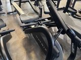 rows of stationary stationary exercise bikes in a gym