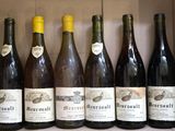 several bottles of wine are lined up in a box