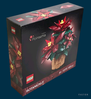 une boîte contenant un poinsettia en Lego, sur fond bleu