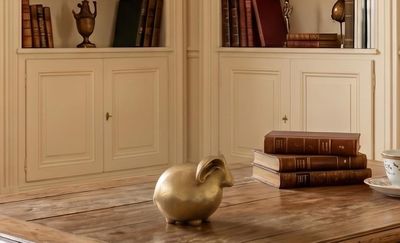 a table with books and a vase on it in a room