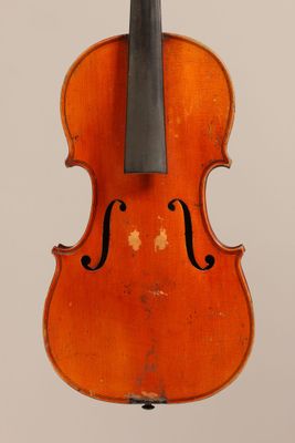 an old violin with a bow hanging from it ' s back